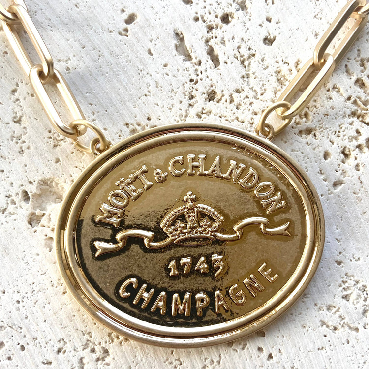 French coin, champagne label statement necklace, gold
