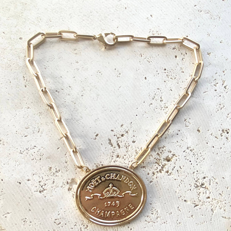 French coin, champagne label statement necklace, gold